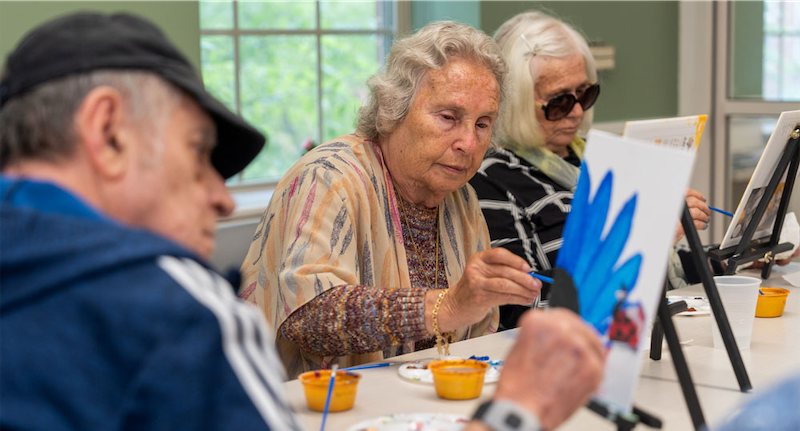 Seniors painting at an art class