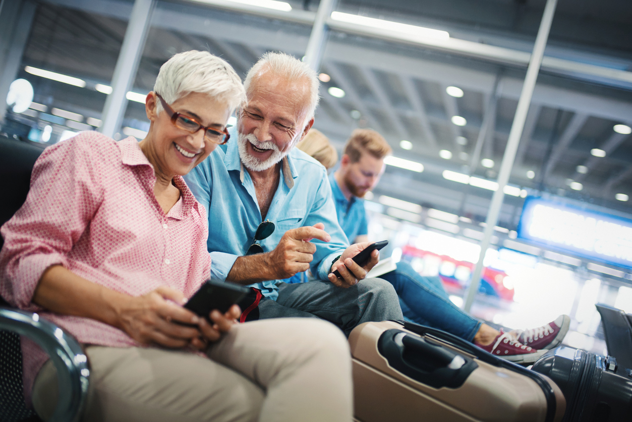 Senior couple waiting to board their flight at the gate