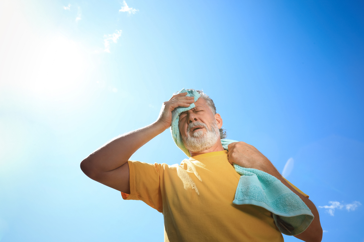 Senior man feeling overheated outside