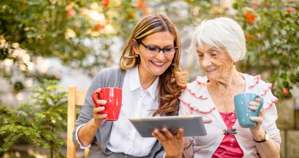 senior woman and daughter looking at tablet together