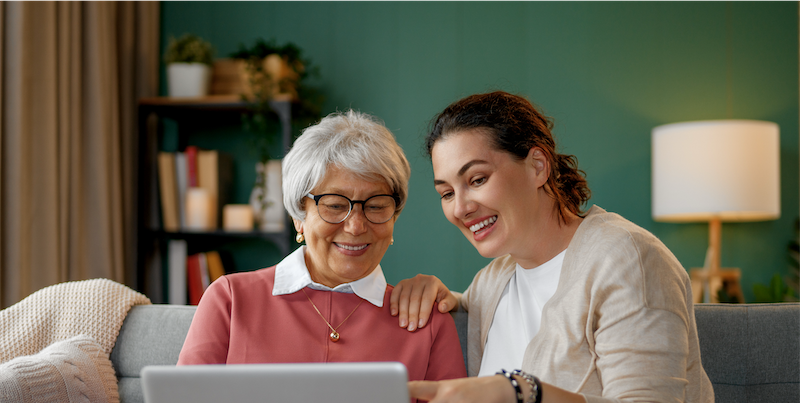Senior with daughter on laptop
